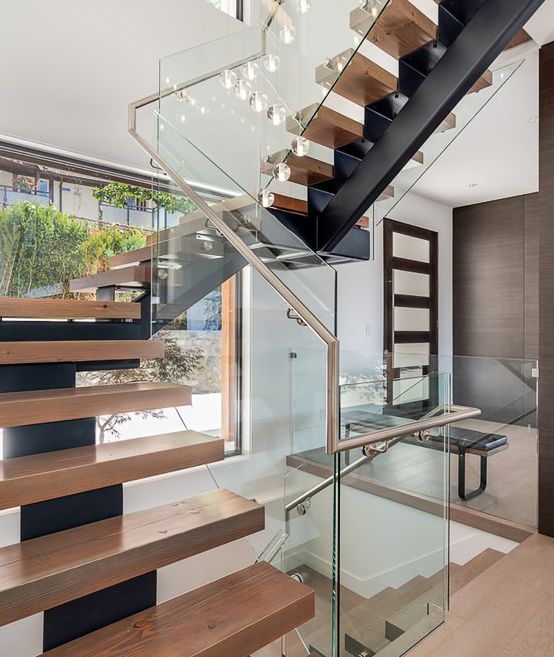 bright home with floating wood steps and framless glass railings in nanaimo